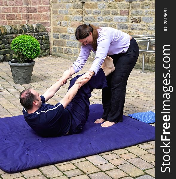 Preparing for shoulder stand as part of a Thai body massage