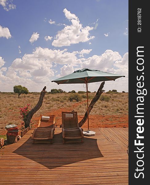 Sunbeds and umbrella in african resort on desert