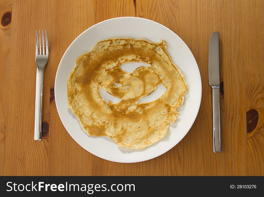 Top view on pancake on white plate