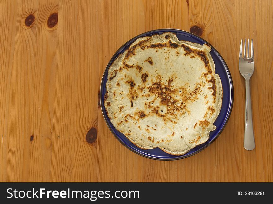 Top view on pancake on blue plate