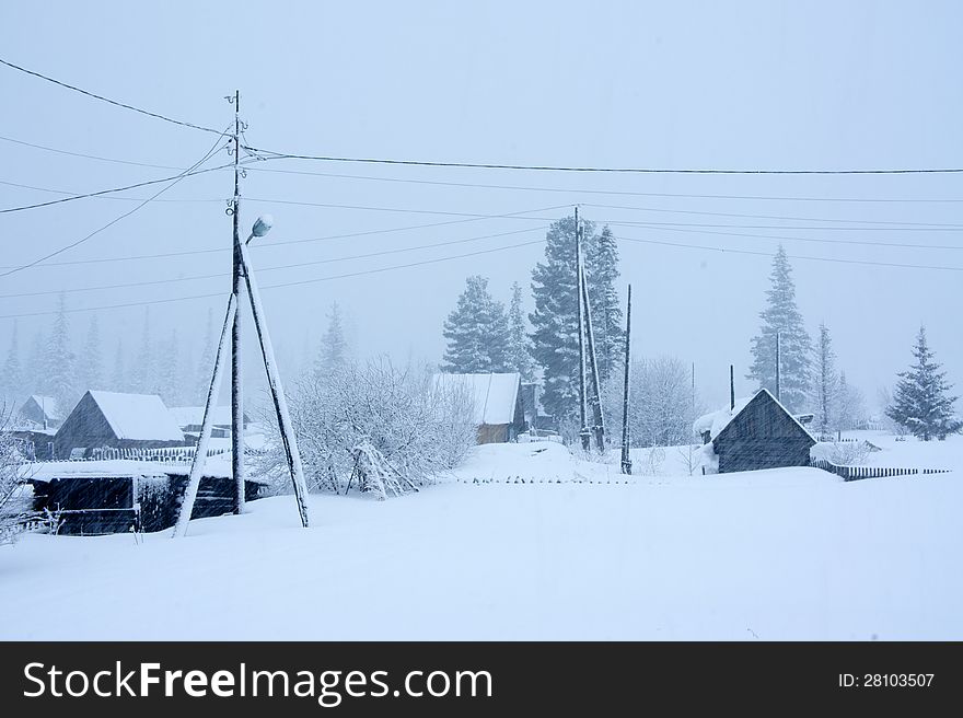 A lamppost and a winter countryside, in a snowstorm of cloudy weather. A lamppost and a winter countryside, in a snowstorm of cloudy weather.