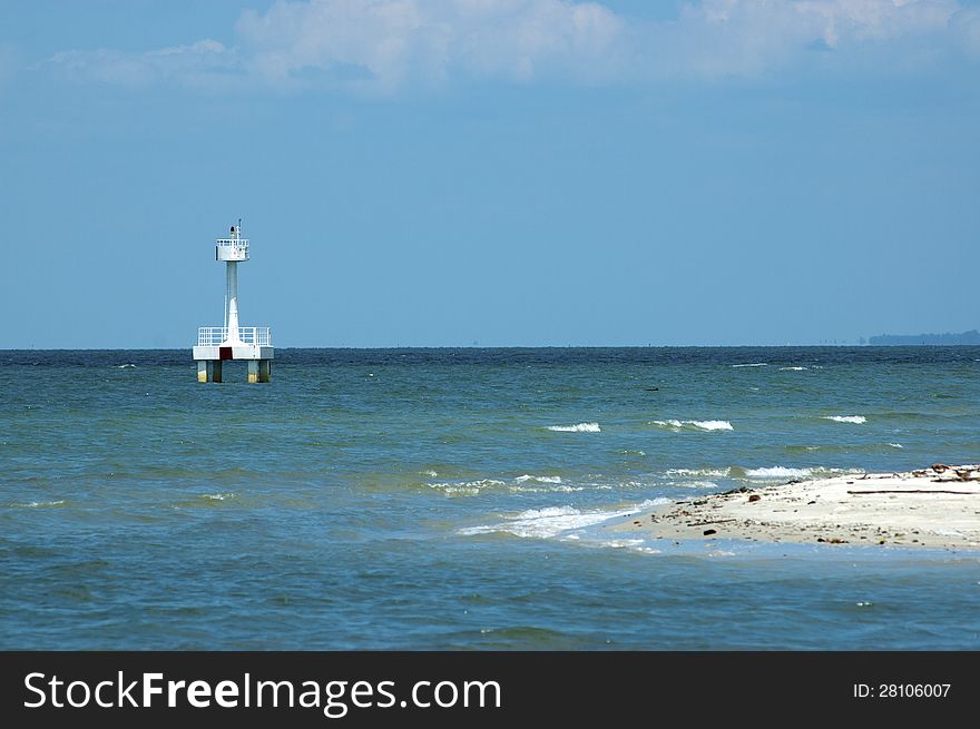 A watch tower stands alone in the middle of the sea. A watch tower stands alone in the middle of the sea