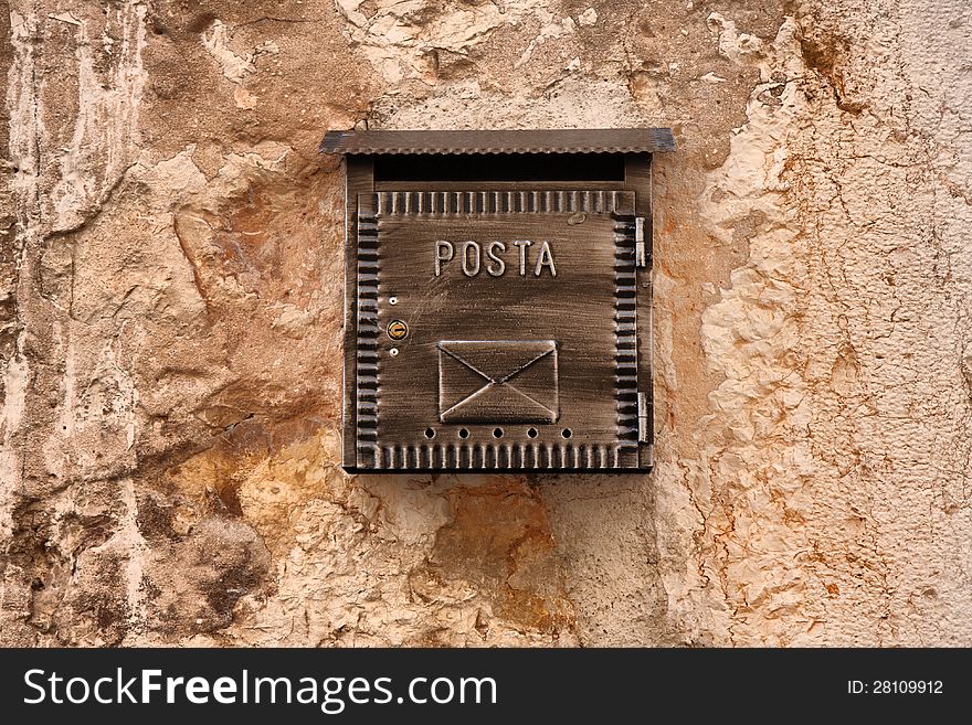 Old mailbox on ancient stone wall