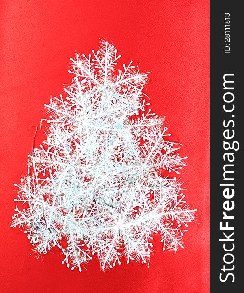 Christmas tree from snowflakes on a red background, christmas decoration. Christmas tree from snowflakes on a red background, christmas decoration