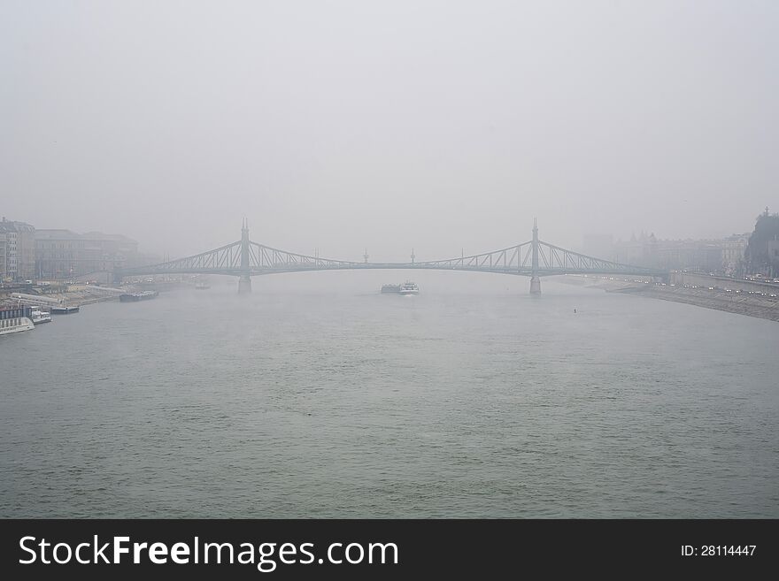 The iconic Liberty Bridge in Budapest in a foggy day. The iconic Liberty Bridge in Budapest in a foggy day