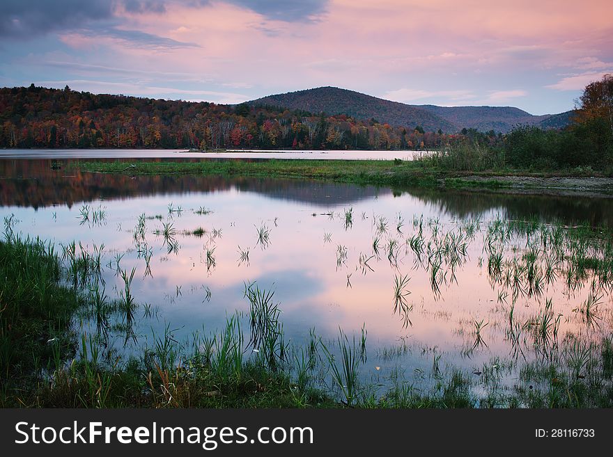Kent Pond in dusk, with hills and foliage in Autumn, near Killington Vermont. Kent Pond in dusk, with hills and foliage in Autumn, near Killington Vermont