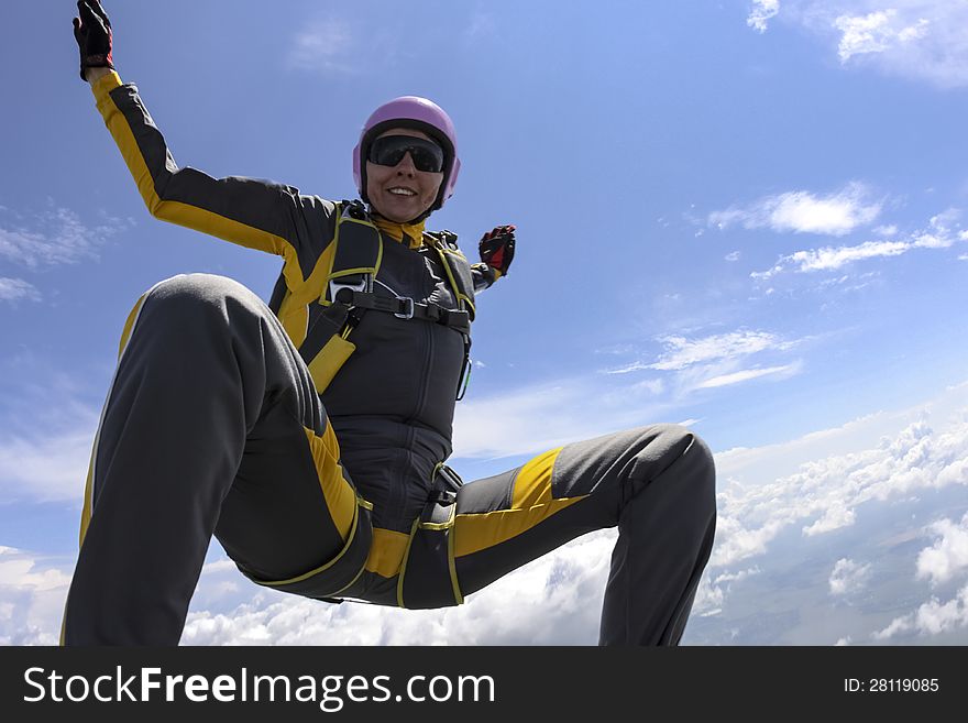 The girl parachutist performs figure freestyle in freefall. The girl parachutist performs figure freestyle in freefall.