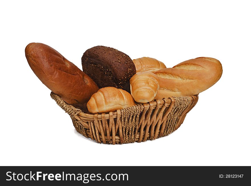 In the wicker basket placed various bread products: wheat, rye, .. small loaves and rolls. In the wicker basket placed various bread products: wheat, rye, .. small loaves and rolls.