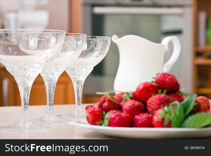 Strawberries and Milk on table in kitchen