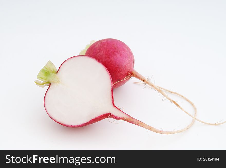 Radish cut one whole other lies next against white background. Radish cut one whole other lies next against white background