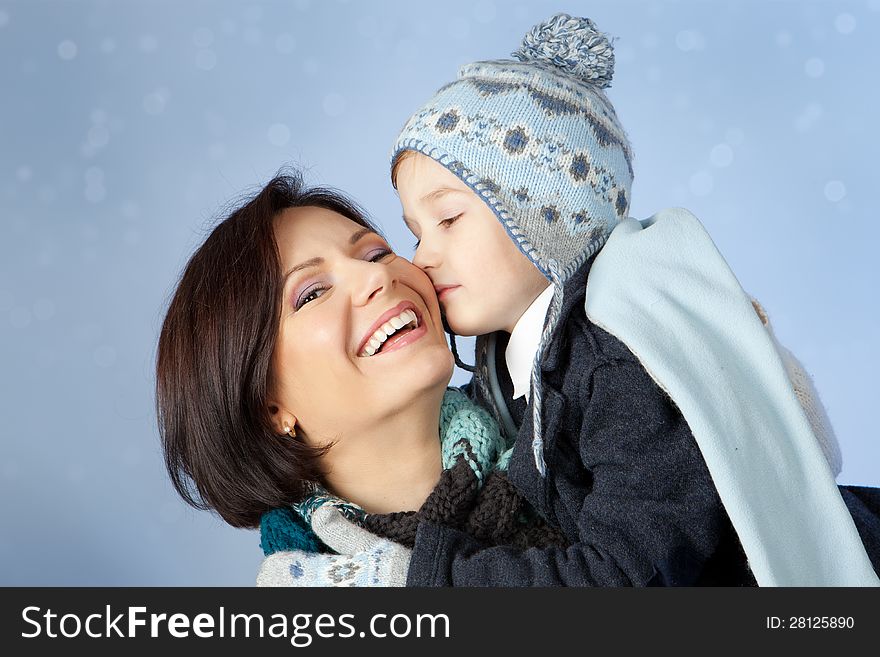 Happy Mother and Son in Winter Clothes