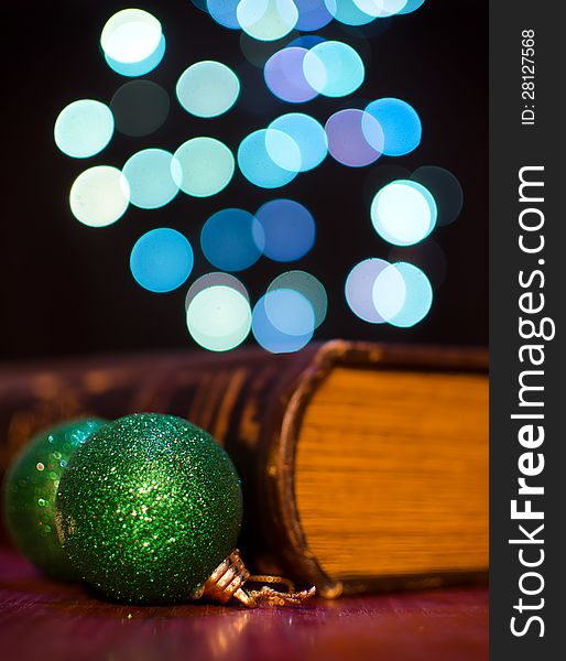 Old book and seasonal decorations on bokeh lights background