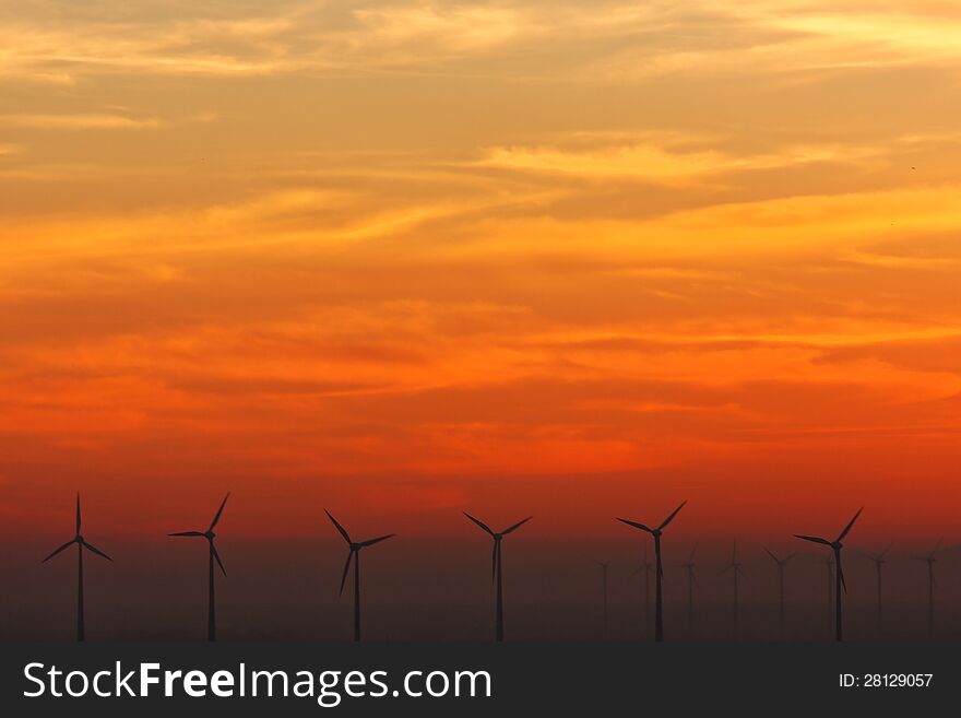 Wind turbines at sundown on the Austrian-Slovak border. Wind turbines at sundown on the Austrian-Slovak border.