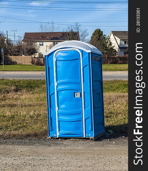 Portable toilets outdoors beside a road