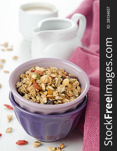 A bowl of homemade granola with goji berries on the table