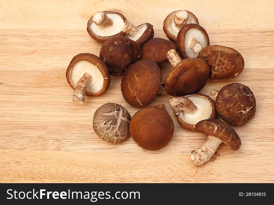 Fresh Mushroom On A Wooden Board