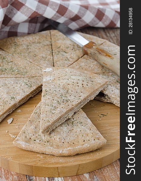 Cut portions flat bread made ​​from rye flour with dill. Cut portions flat bread made ​​from rye flour with dill