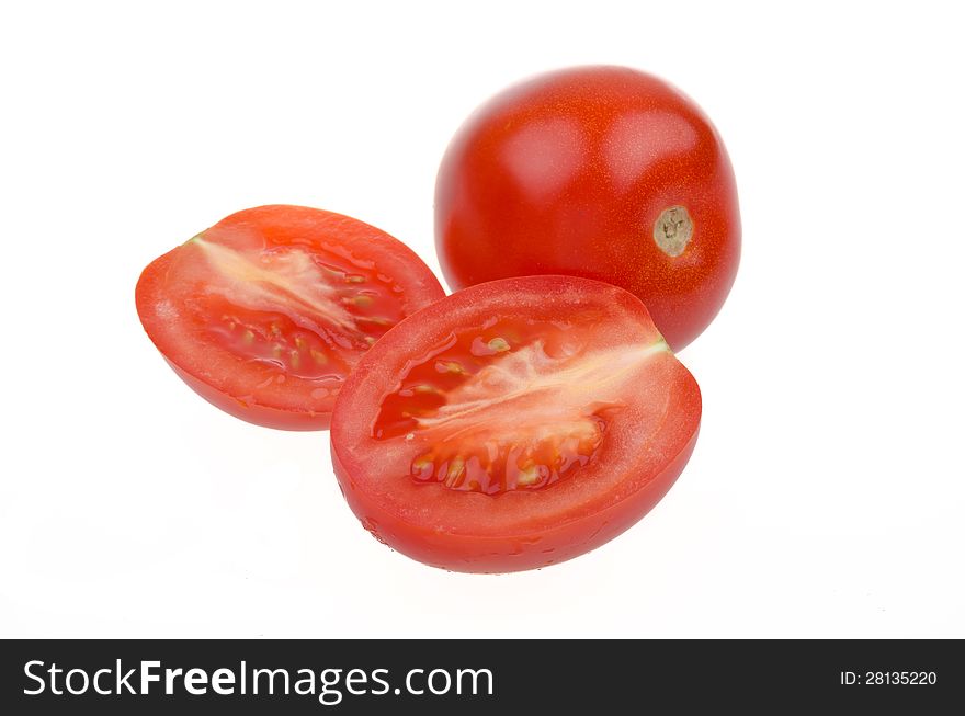 Whole tomatoes and cut in half isolated on white background closeup