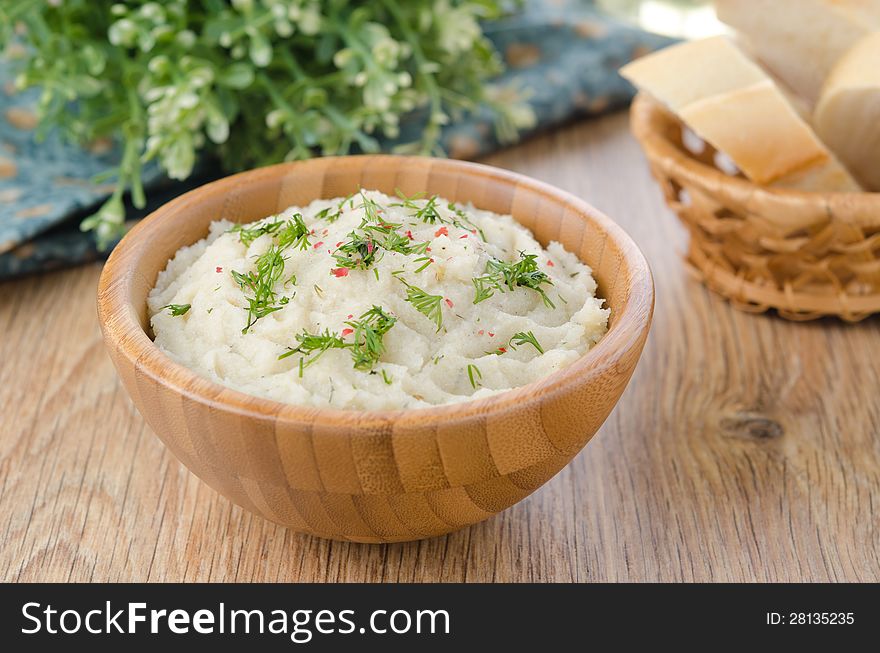 Mashed potatoes and cabbage in a wooden bowl on the table, selective focus