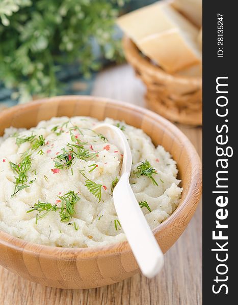 Mashed potatoes and cabbage in a bowl on a wooden table, closeup. Mashed potatoes and cabbage in a bowl on a wooden table, closeup