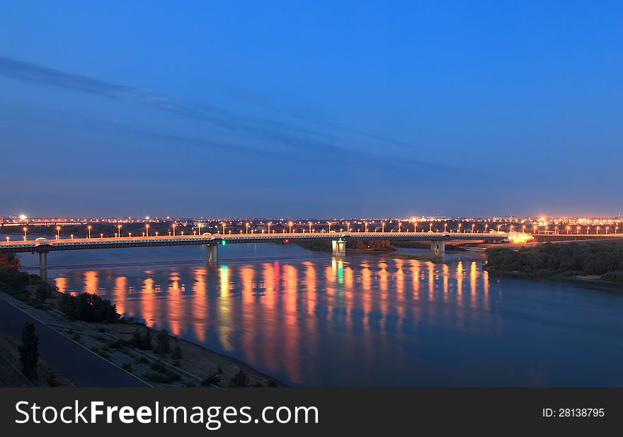 Bridge named after the sixtieth anniversary of victory. Irtysh River. Omsk. Russia. Night landscape. Bridge named after the sixtieth anniversary of victory. Irtysh River. Omsk. Russia. Night landscape.