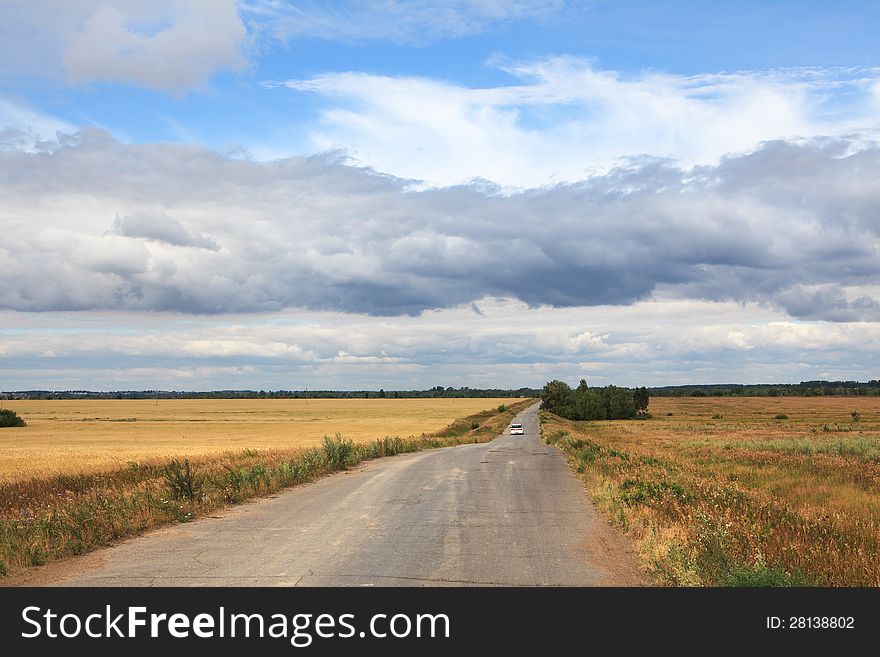 Storm clouds over the road in the steppe.