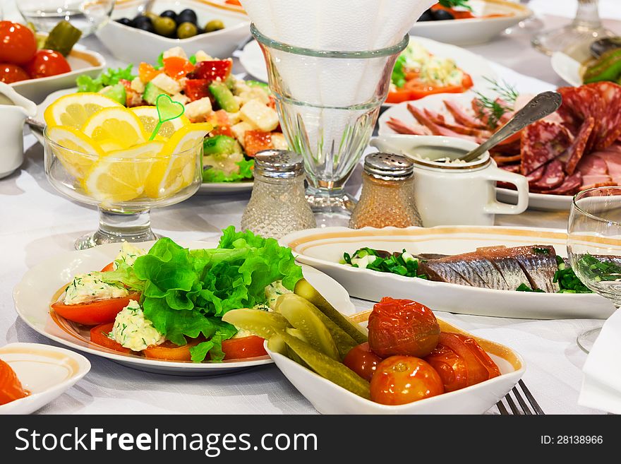 Fresh salads and fish on holiday table