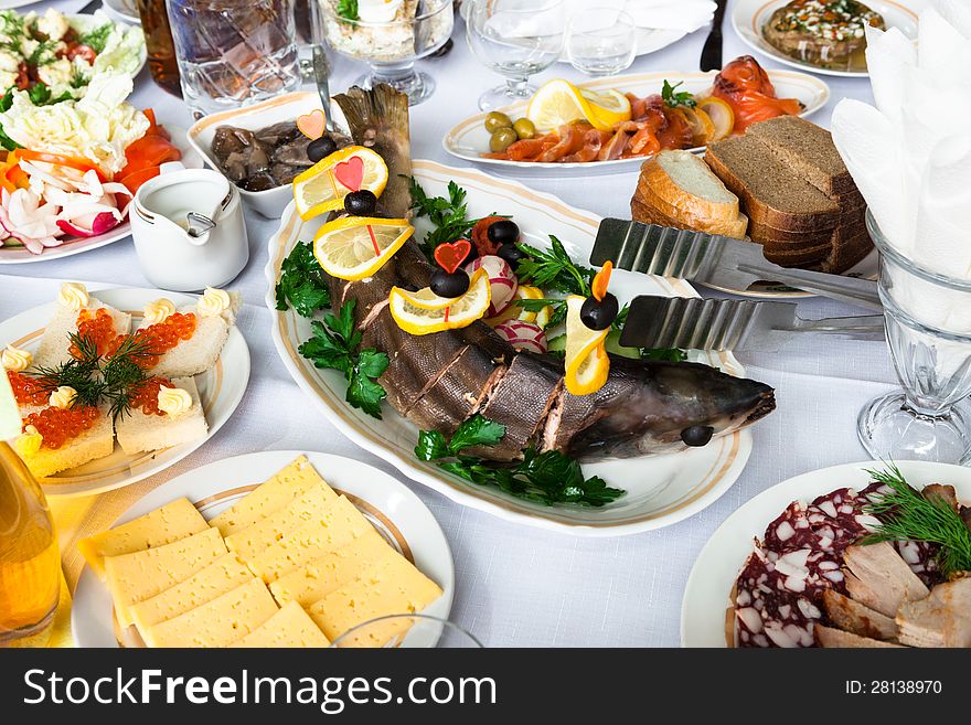 Fresh fish and snacks on holiday table