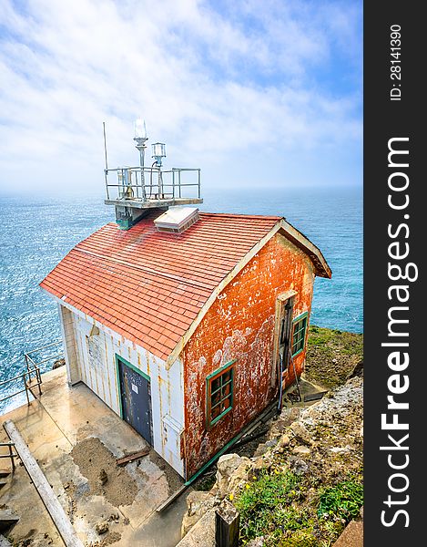 Old colorful beautiful house on the edge of the earth and the deep blue ocean behind. Old colorful beautiful house on the edge of the earth and the deep blue ocean behind