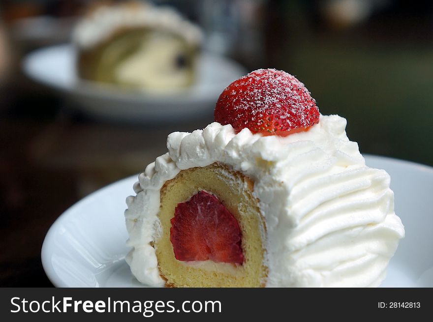 Vanilla And Cream Cake With A Strawberry Slice.