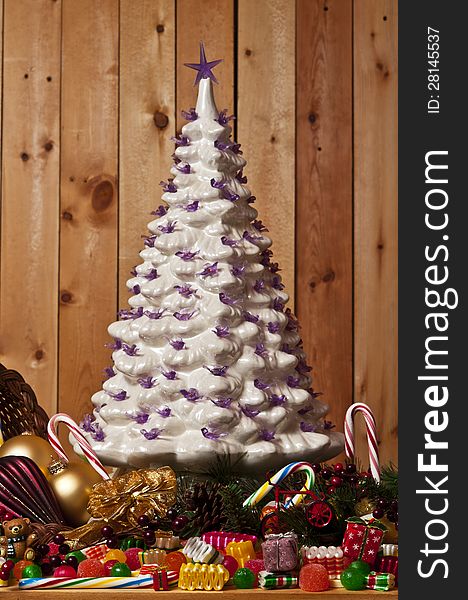 Ceramic crafted christmas tree surrounded by a cornucopia of candy. Ceramic crafted christmas tree surrounded by a cornucopia of candy