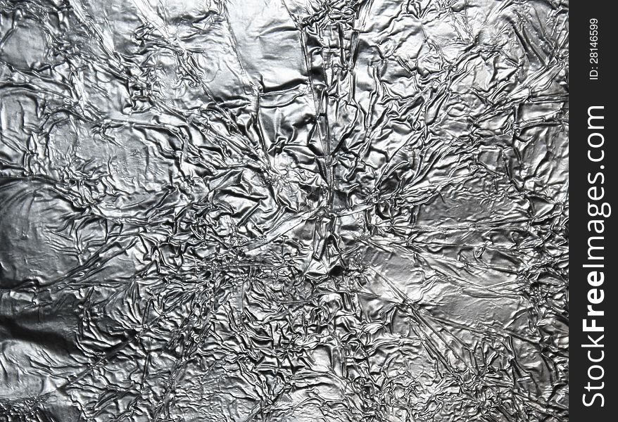 Silver crumpled foil surface background. Silver crumpled foil surface background