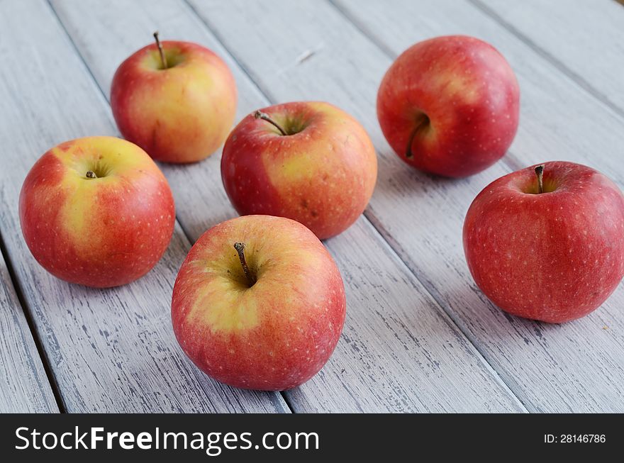 Ripe apples on shabby wooden table