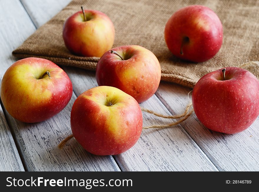 Ripe apples on shabby wooden table