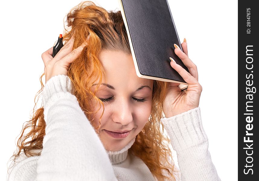 Education. Tired girl holds a notebook on her head on a white background. Education. Tired girl holds a notebook on her head on a white background