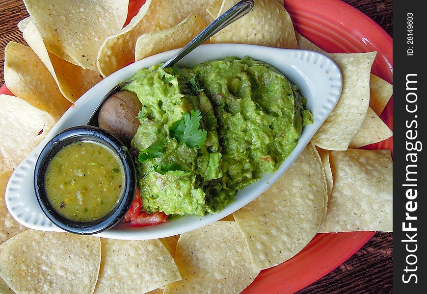 Closeup of guacamole with tortilla chips served on a plate