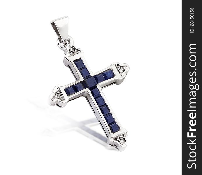 A blue sapphire and white gold cross pendant on white background. A blue sapphire and white gold cross pendant on white background