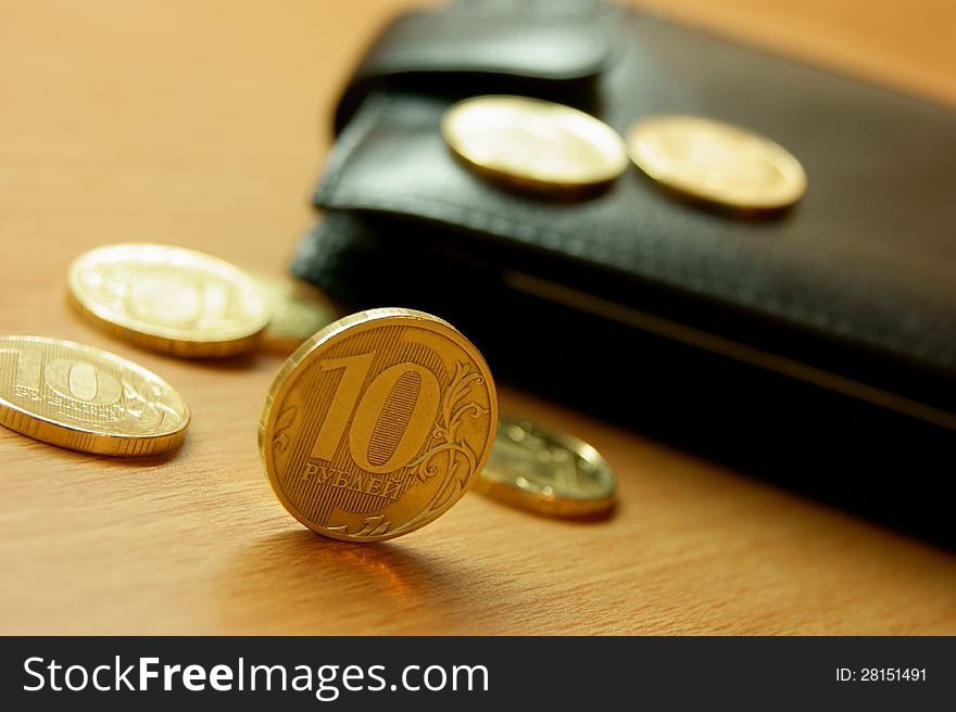 Shiny coins on the background of the leather wallet. Shiny coins on the background of the leather wallet