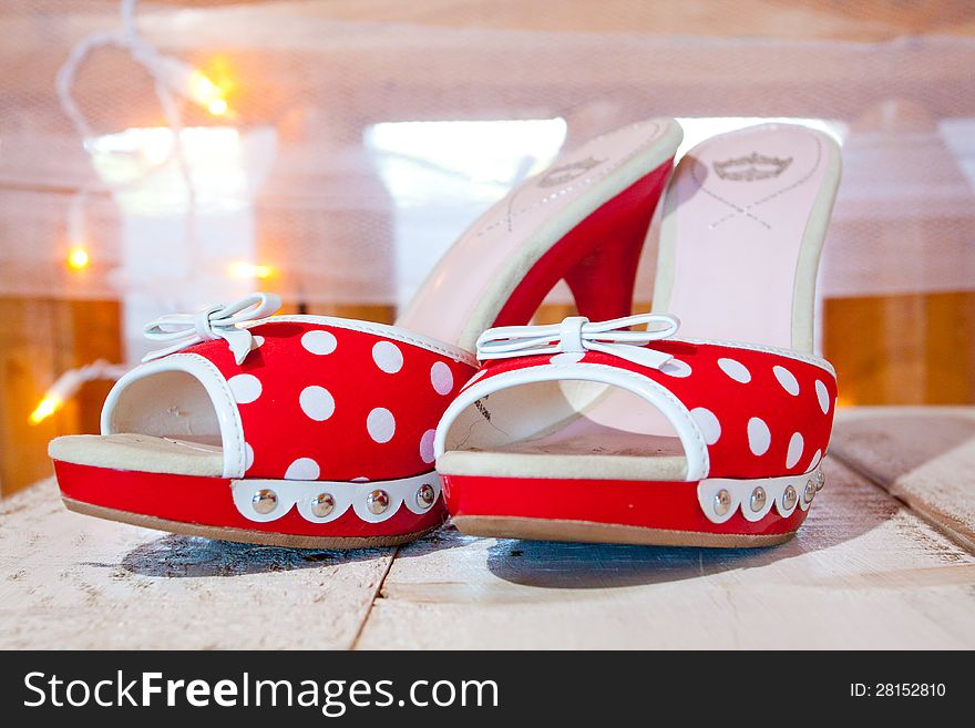 A bride's wedding shoes in red and white with polkadots and heels. A bride's wedding shoes in red and white with polkadots and heels.