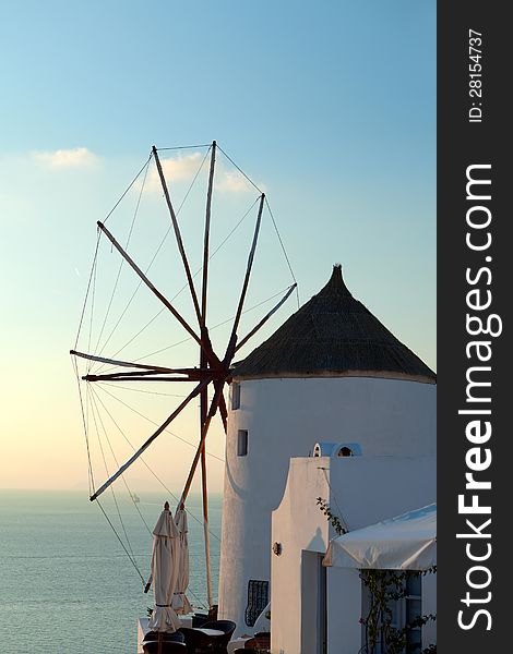 Windmill at sunrise in Oia Village. Santorini. Greece. Windmill at sunrise in Oia Village. Santorini. Greece.