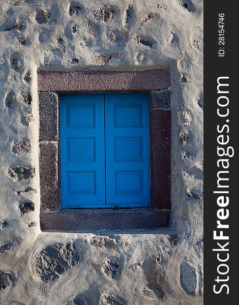 Old window closed blue shutters, Greece, Santorini island