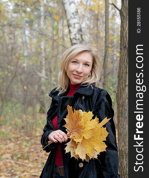 Woman Holding Autumn Leaves