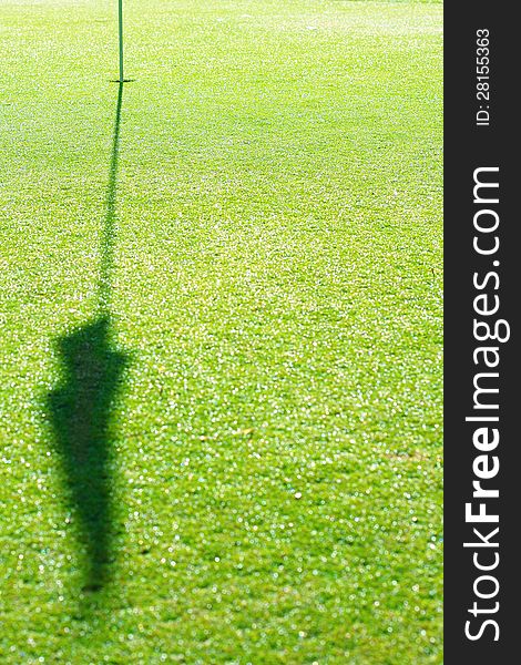Golf Hole with shadow of flag on green