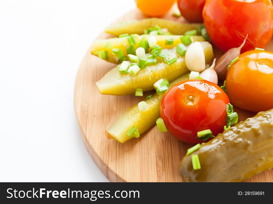 Pickled vegetables - assorted on a wooden surface