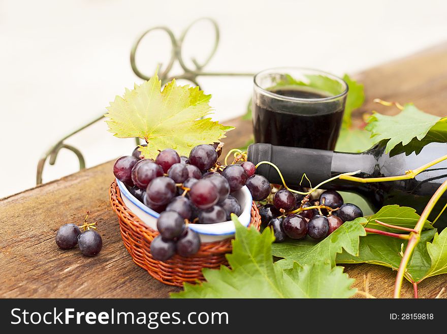 Fresh grapes and bottles of wine