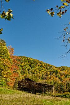 An Old Barn Sits Among Fall Leaves And A Blue Sky. Stock Photography An Old Barn Sits Among Fall Leaves And A Blue Sky. Stock Photography