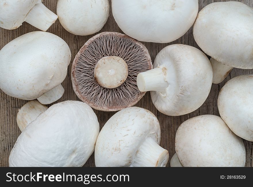 Mushroom champignon group on wood texture