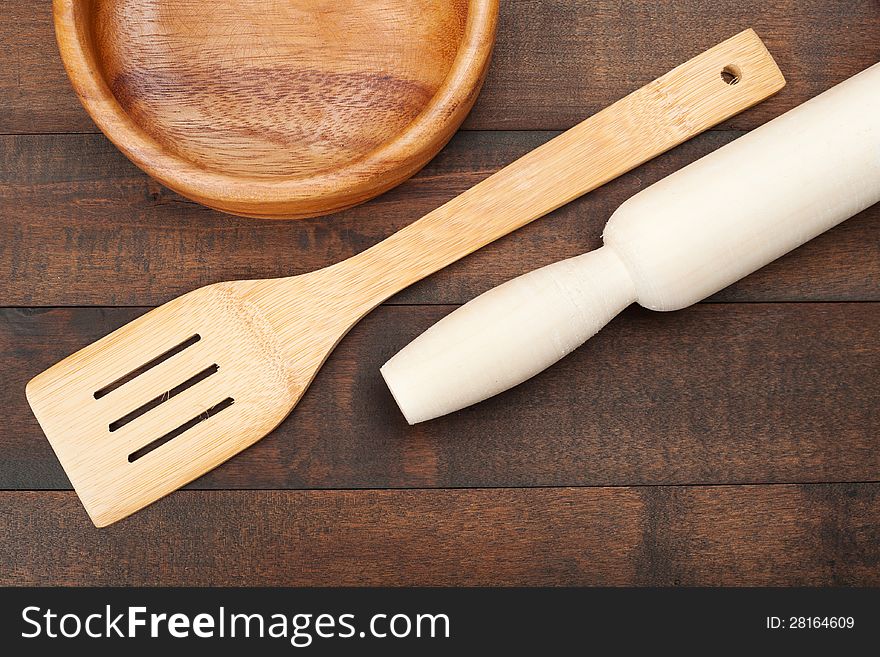 Wooden kitchen utensil: plate, rolling pin, spoon for stirring,top view