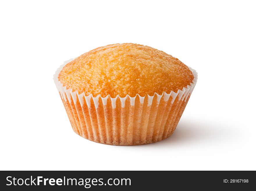 Cupcake in paper bakeware. Closeup. Laying on a white.