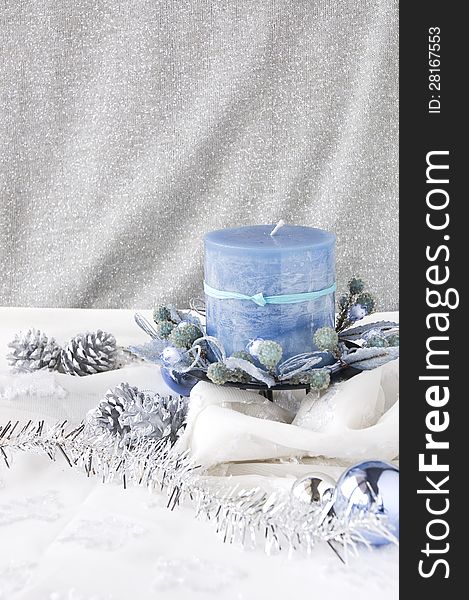 Blue candle decorated on white and silver background. Blue candle decorated on white and silver background